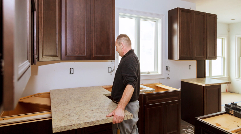 man installing kitchen cabinets and countertop Sarasota FL